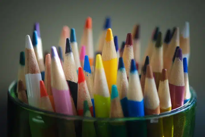 a cup full of colored pencils