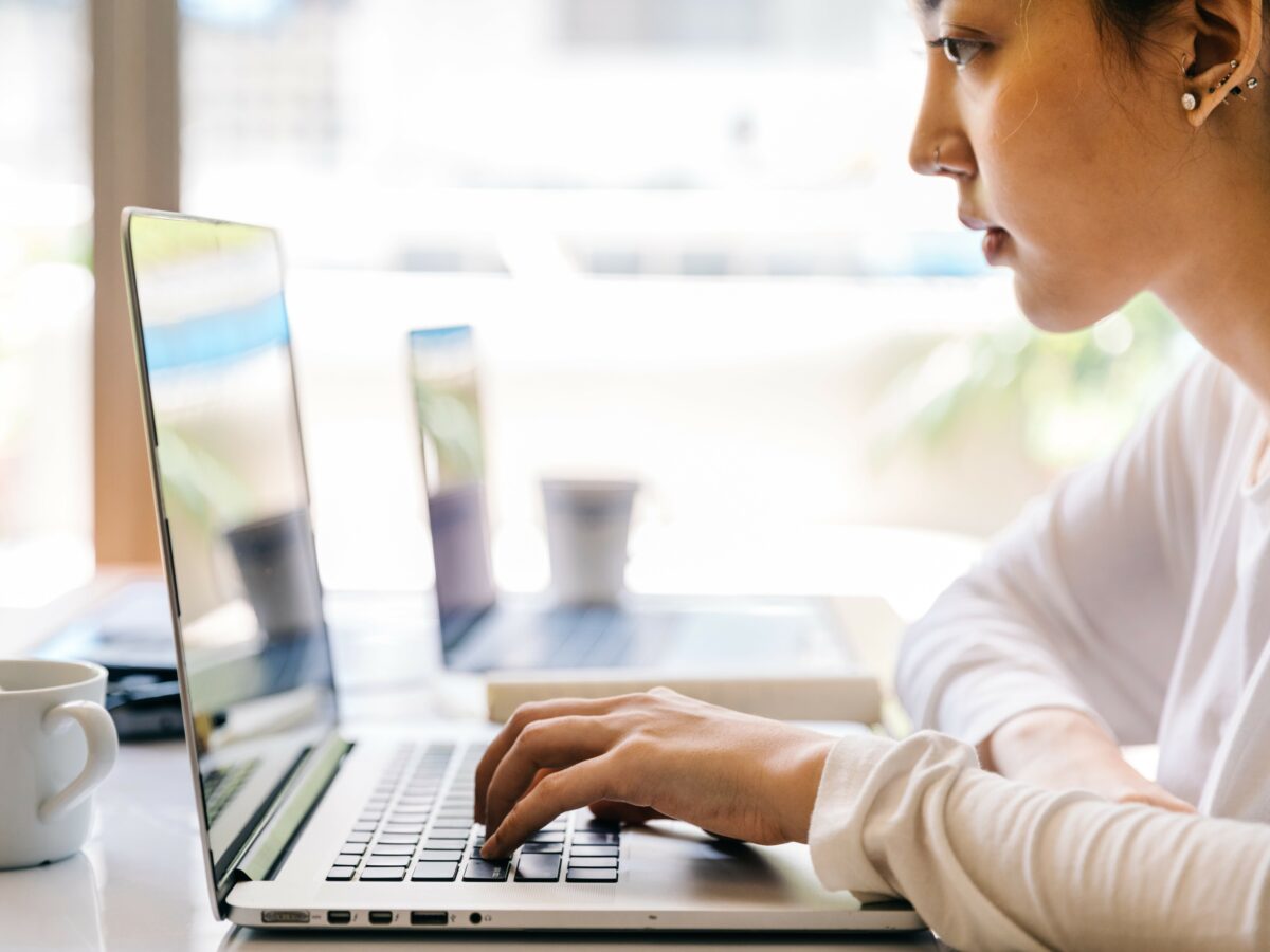 woman using a laptop to review SERP as a result of video SEO