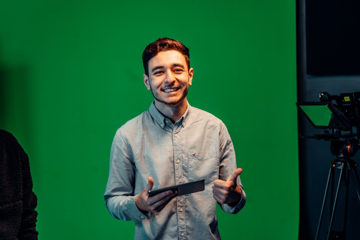 video spokesperson standing against a green screen